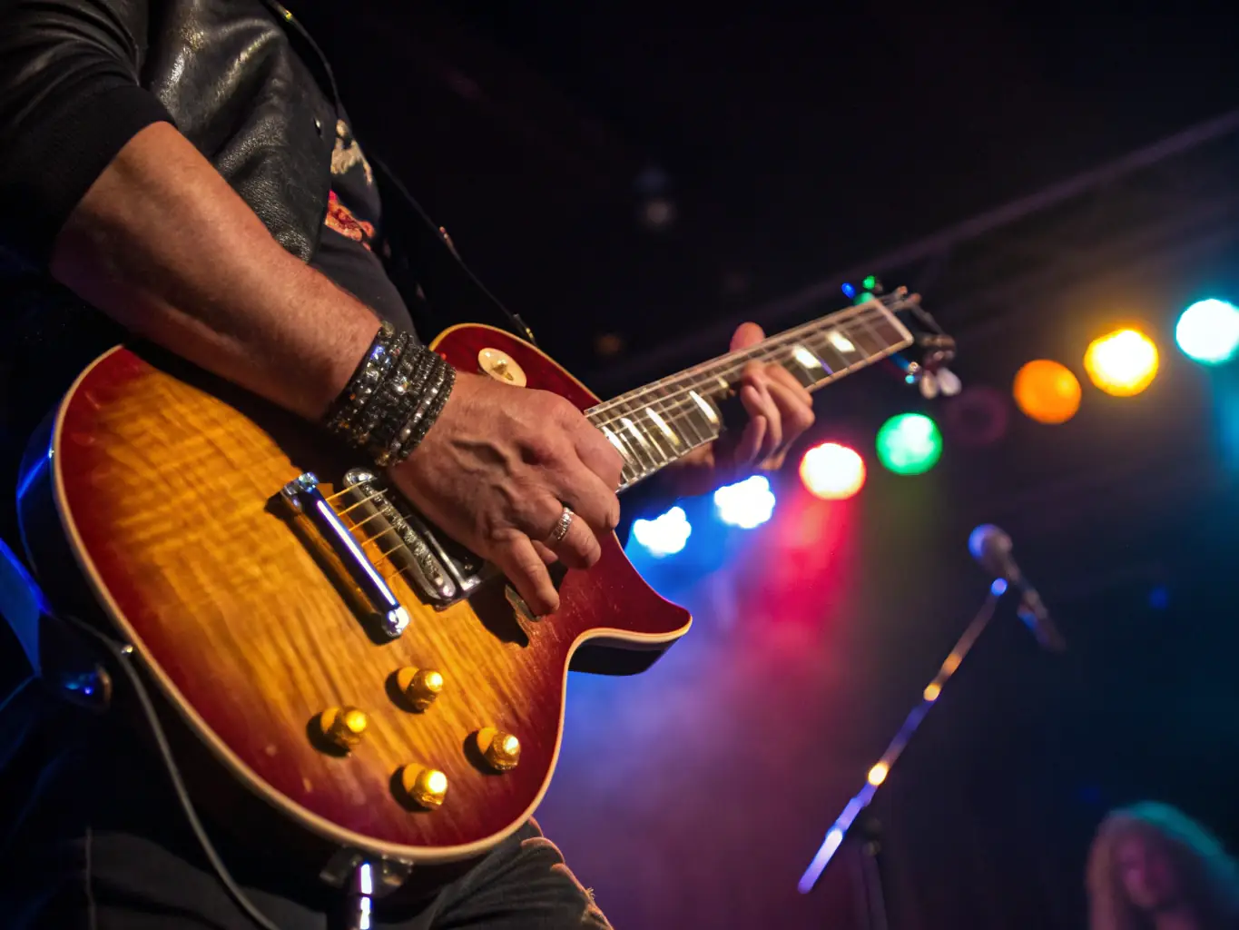 A musician performing on stage at an ARAGONNE-sponsored event, highlighting the organization's commitment to showcasing emerging talents.